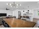 Open concept living space featuring a dining area, living room, and a modern kitchen with a center island and bar seating at 4634 E Wilshire Dr, Phoenix, AZ 85008