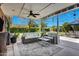 Inviting covered patio with comfortable seating, ceiling fan, and views of the backyard at 4634 E Wilshire Dr, Phoenix, AZ 85008