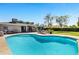 Refreshing pool area with sun loungers and lush backyard landscaping at 4634 E Wilshire Dr, Phoenix, AZ 85008