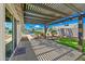 Relaxing backyard patio with pergola, view of the pool and lush tropical landscaping at 4902 E Golden St, Mesa, AZ 85205