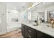Bright bathroom featuring dual sinks, a white marble countertop, and a shower at 4902 E Golden St, Mesa, AZ 85205