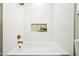 Updated bathtub features a tile surround and a storage niche at 4902 E Golden St, Mesa, AZ 85205