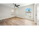 Bright bedroom featuring wood-look floors, ceiling fan, and a large arched window at 4902 E Golden St, Mesa, AZ 85205