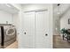 Hallway leading to laundry room with sliding closet doors, modern lighting, and decor at 4902 E Golden St, Mesa, AZ 85205