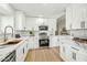 Bright kitchen with white cabinets, marble countertops, and stainless steel appliances at 4902 E Golden St, Mesa, AZ 85205