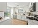 Bright kitchen with white cabinets, stainless steel appliances, marble countertops, and stylish modern fixtures at 4902 E Golden St, Mesa, AZ 85205
