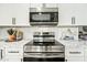 Modern kitchen featuring stainless steel appliances, marble countertops, and sleek white cabinetry for a luxurious feel at 4902 E Golden St, Mesa, AZ 85205
