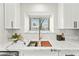 Modern kitchen sink with marble countertop, stylish fixtures, and a bright window offering natural light at 4902 E Golden St, Mesa, AZ 85205