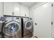 Well-equipped laundry room features a modern washer and dryer with white cabinets at 4902 E Golden St, Mesa, AZ 85205