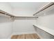 Bright walk-in closet features custom wood shelving, laminate floors, and fresh paint at 4902 E Golden St, Mesa, AZ 85205
