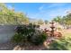 Landscaped backyard with fountain, flowering bushes, and brick border at 5090 E Sleepy Ranch Rd, Cave Creek, AZ 85331