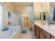 Bathroom with a soaking tub, shower, and double sinks, decorated in neutral tones at 5090 E Sleepy Ranch Rd, Cave Creek, AZ 85331