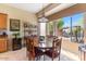 Cozy dining area adjacent to the kitchen, featuring a wooden table and large windows offering scenic views at 5090 E Sleepy Ranch Rd, Cave Creek, AZ 85331
