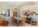 Formal dining room with a wooden table, chandelier, and a window with shuttered blinds at 5090 E Sleepy Ranch Rd, Cave Creek, AZ 85331