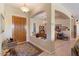 Inviting foyer with a wooden front door, tile flooring, and views into the dining room and living areas at 5090 E Sleepy Ranch Rd, Cave Creek, AZ 85331