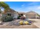 Charming single-story home with a stone facade, desert landscaping, and a two-car garage at 5090 E Sleepy Ranch Rd, Cave Creek, AZ 85331