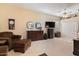 Spacious living room with ceiling fan, dresser, tv, and comfortable seating area at 5090 E Sleepy Ranch Rd, Cave Creek, AZ 85331
