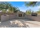 Outdoor fireplace with grill, tiled backsplash, and desert landscaping at 5090 E Sleepy Ranch Rd, Cave Creek, AZ 85331
