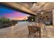 Relaxing backyard with a covered patio, outdoor dining, a sparkling pool and a fire pit at 6535 W Gold Mountain Pass, Phoenix, AZ 85083