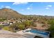 Desert home featuring a private pool, spa, covered patio, and landscaped backyard with mountain views at 6535 W Gold Mountain Pass, Phoenix, AZ 85083
