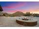 Desert backyard with travertine tile, fire pit, mountain views and desert landscaping at 6535 W Gold Mountain Pass, Phoenix, AZ 85083