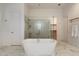 Elegant bathroom showcasing a freestanding tub, glass shower, and marble flooring for a luxurious feel at 6535 W Gold Mountain Pass, Phoenix, AZ 85083