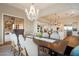 Dining room boasts a decorative chandelier, seating for ten, and access to the kitchen at 6535 W Gold Mountain Pass, Phoenix, AZ 85083