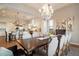 Dining room boasts a decorative chandelier, seating for ten, and access to the kitchen at 6535 W Gold Mountain Pass, Phoenix, AZ 85083