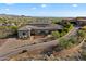 Beautiful single-story home with desert landscaping, three car garage and brick paved driveway at 6535 W Gold Mountain Pass, Phoenix, AZ 85083