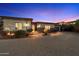 Lovely desert home with stone accents, manicured shrubbery, and a brick driveway with lighted pathway at 6535 W Gold Mountain Pass, Phoenix, AZ 85083