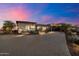 Desert home featuring professional landscaping, automatic landscape lighting and a paver driveway at 6535 W Gold Mountain Pass, Phoenix, AZ 85083