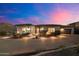 Beautiful single-story home with desert landscaping, a stone accent wall and paver driveway at dusk at 6535 W Gold Mountain Pass, Phoenix, AZ 85083