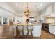 Bright kitchen features stainless steel appliances, granite counters, hardwood floors and large center island at 6535 W Gold Mountain Pass, Phoenix, AZ 85083