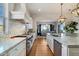 Well-appointed kitchen boasts stainless appliances, custom backsplash, and a seamless flow to the dining area at 6535 W Gold Mountain Pass, Phoenix, AZ 85083