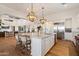 Open-concept kitchen boasts a large island with seating, stainless steel appliances, and easy access to living spaces at 6535 W Gold Mountain Pass, Phoenix, AZ 85083