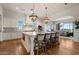 Gourmet kitchen featuring a large island with seating, pendant lighting, and stainless steel appliances at 6535 W Gold Mountain Pass, Phoenix, AZ 85083