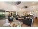 Spacious living room features high ceilings, hardwood floors, a large sectional, and access to an outdoor patio at 6535 W Gold Mountain Pass, Phoenix, AZ 85083