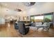 Bright living room boasts hardwood floors, high ceilings, stylish decor, and seamless indoor/outdoor living with picturesque views at 6535 W Gold Mountain Pass, Phoenix, AZ 85083