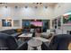 Cozy living room includes comfortable seating, built-in shelving, a fireplace, and sliding glass doors with sunset views at 6535 W Gold Mountain Pass, Phoenix, AZ 85083