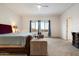 Bedroom features a king bed, seating area, dresser and an ensuite bathroom at 6535 W Gold Mountain Pass, Phoenix, AZ 85083