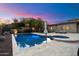Enjoy this sparkling pool, hot tub and fire pit in the backyard at 6535 W Gold Mountain Pass, Phoenix, AZ 85083