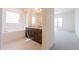 Modern bathroom with a soaking tub, dark wood vanity, and tile flooring at 6728 N 190Th Dr, Waddell, AZ 85355