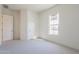 Bright bedroom featuring carpeted floors, and two entry doors at 6728 N 190Th Dr, Waddell, AZ 85355