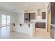 Modern kitchen with a central island, sleek cabinetry, stainless steel appliances, and ample counter space at 6728 N 190Th Dr, Waddell, AZ 85355