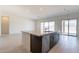 Kitchen island with a dishwasher, a view to the backyard, a sink, and tile flooring at 6728 N 190Th Dr, Waddell, AZ 85355