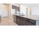 Kitchen island with a stainless steel dishwasher, modern faucet, and cabinets and white backsplash at 6728 N 190Th Dr, Waddell, AZ 85355