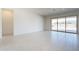 Spacious living area with tile flooring, sliding glass doors to the backyard, and neutral walls at 6728 N 190Th Dr, Waddell, AZ 85355