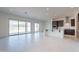 Open floor plan featuring tile flooring, sliding glass doors to the backyard, and a modern kitchen area at 6728 N 190Th Dr, Waddell, AZ 85355