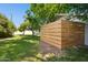Beautiful backyard with lush green grass, mature trees, and a modern wood fence at 6800 E Exeter Blvd, Scottsdale, AZ 85251