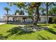 Inviting backyard featuring a covered patio, outdoor seating, and a well-maintained lawn under a large shade tree at 6800 E Exeter Blvd, Scottsdale, AZ 85251